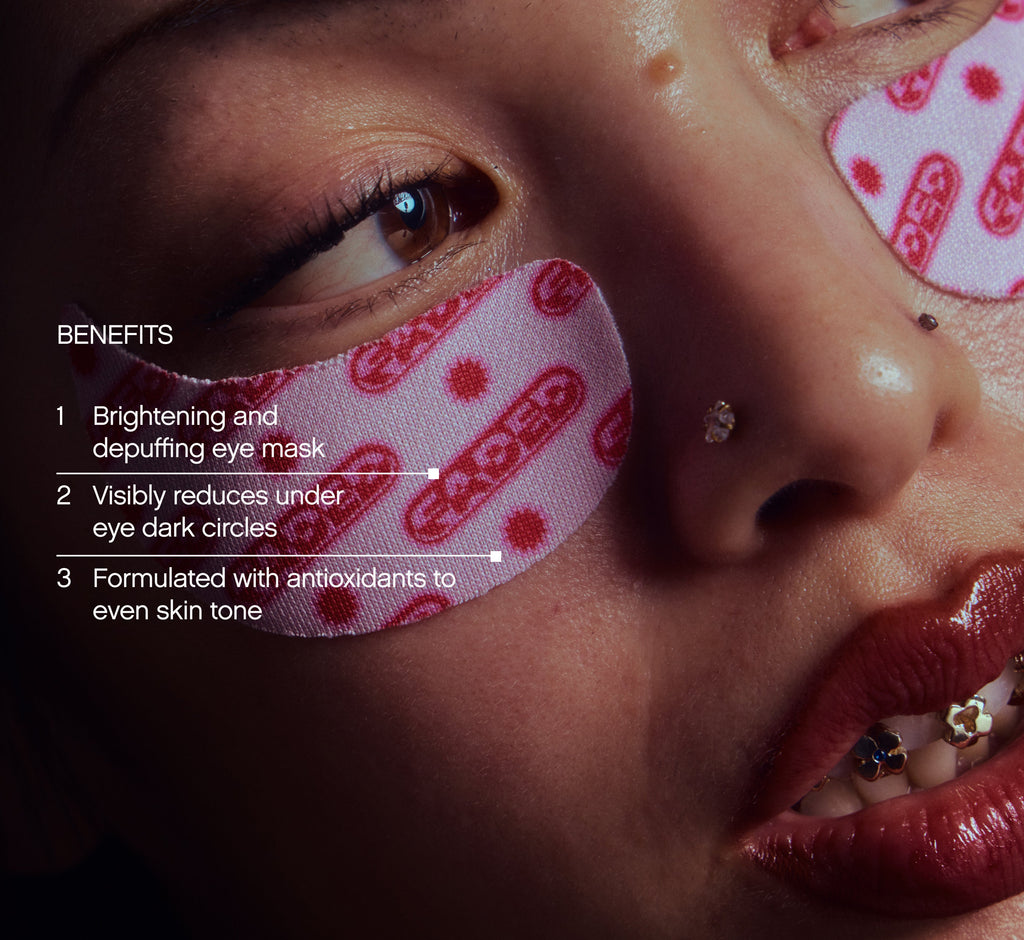 Under eye brightening patches from Topicals Faded shown applied beneath a model's eye, with callouts highlighting benefits including depuffing, reducing dark circles, and evening skin tone.